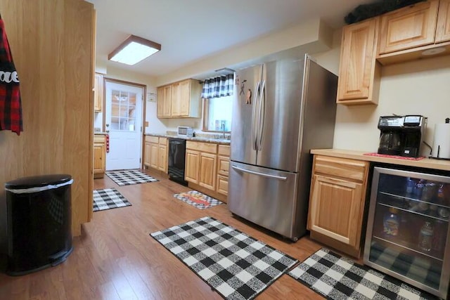 kitchen with stainless steel refrigerator, dishwasher, light hardwood / wood-style floors, and wine cooler