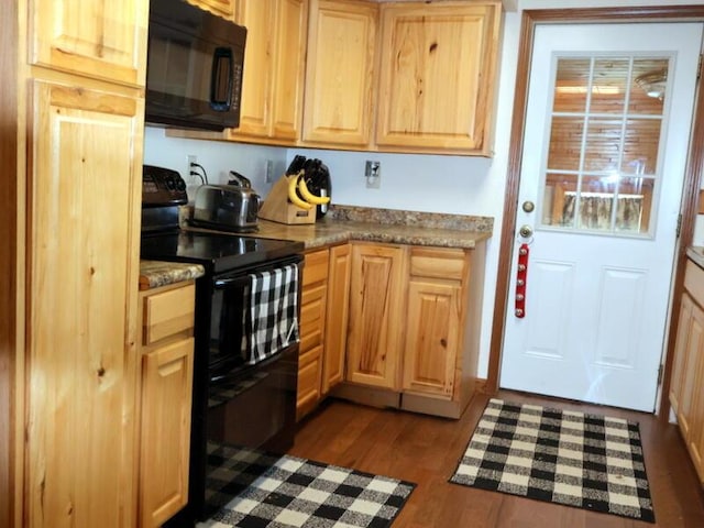 kitchen featuring black appliances, light brown cabinets, and dark wood-type flooring