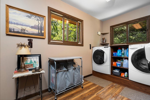 clothes washing area featuring washing machine and clothes dryer and dark hardwood / wood-style flooring