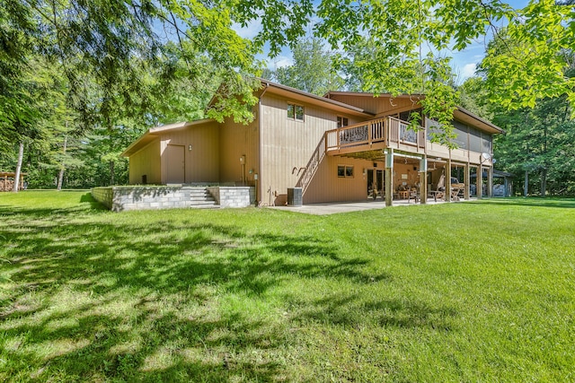 back of property featuring a lawn, central AC unit, a patio area, and a deck