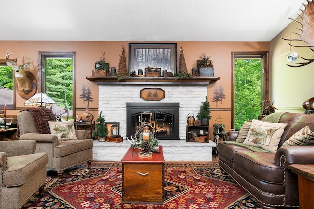 living room with plenty of natural light and a fireplace