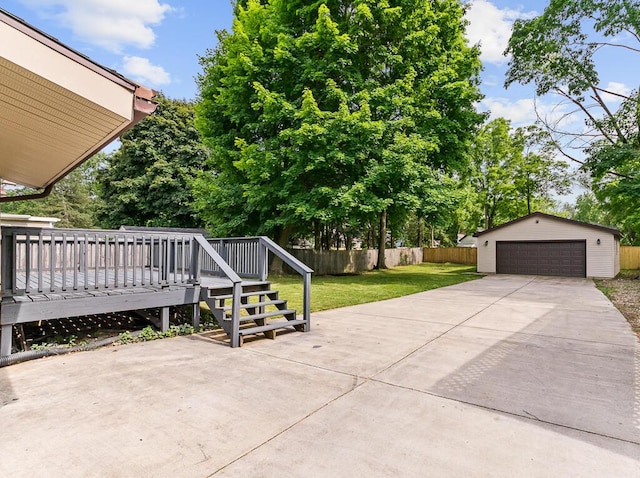 view of patio / terrace featuring an outbuilding, a deck, and a garage