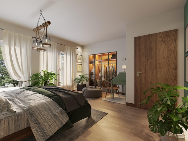 bedroom featuring multiple windows, a chandelier, and light hardwood / wood-style flooring