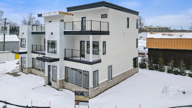 snow covered house with a balcony