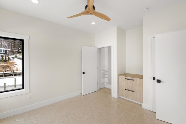 unfurnished bedroom featuring light carpet and ceiling fan