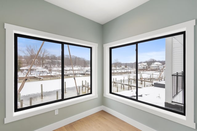 unfurnished room featuring hardwood / wood-style floors and plenty of natural light