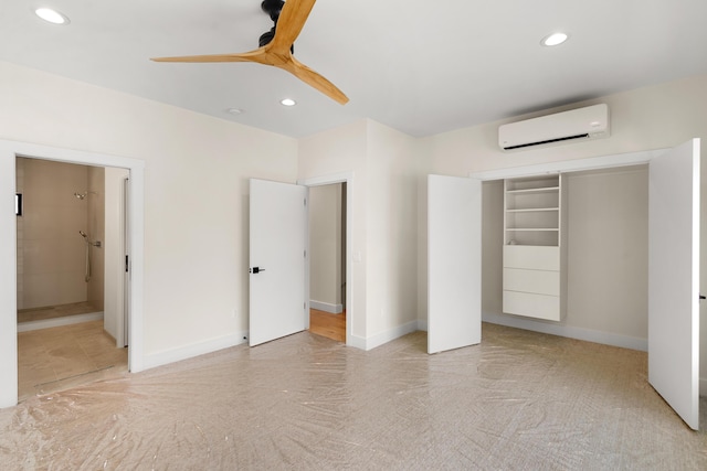 unfurnished bedroom with ceiling fan, a closet, a wall mounted AC, and ensuite bathroom