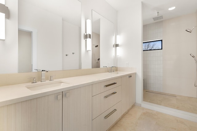 bathroom featuring vanity and tiled shower