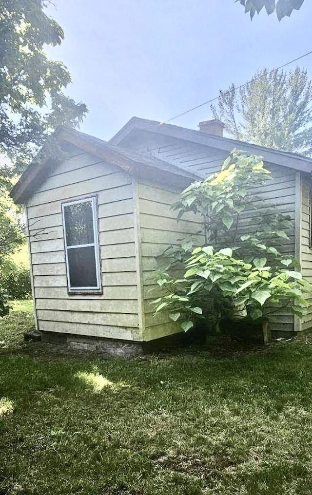 view of side of property with a lawn