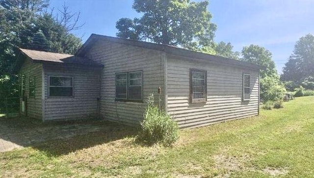 view of side of home featuring a yard