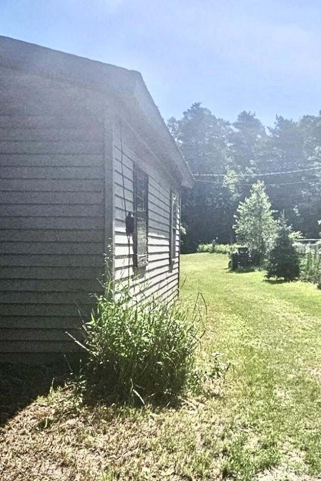 view of side of property with a lawn