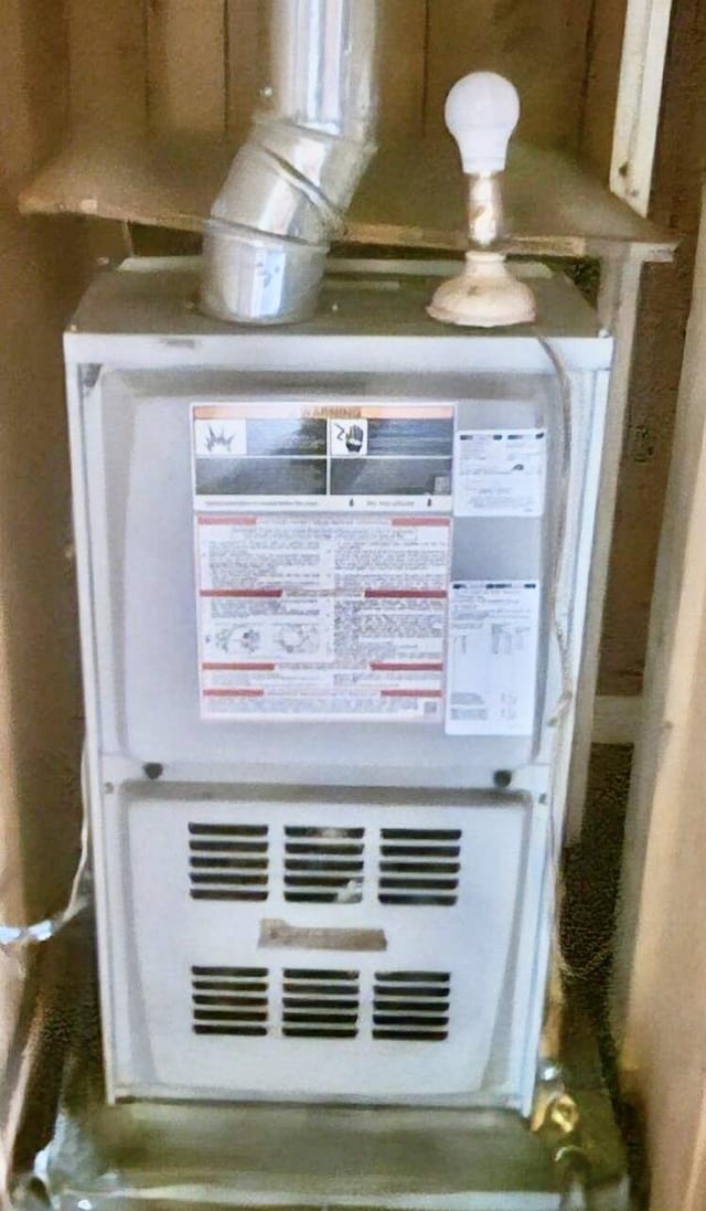 utility room featuring heating unit