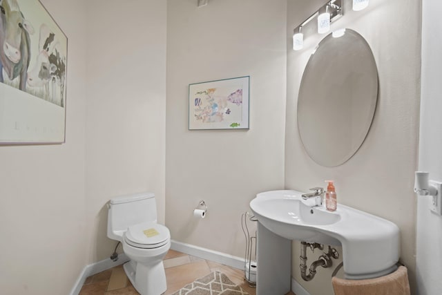 bathroom with tile patterned flooring and toilet