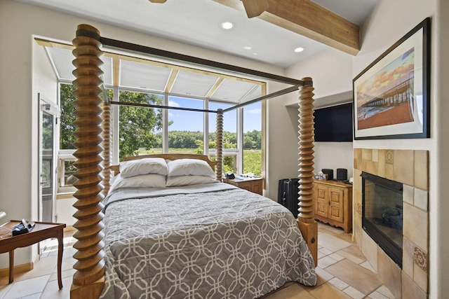 bedroom featuring beam ceiling, radiator, and a tile fireplace