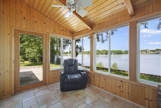 unfurnished sunroom featuring vaulted ceiling with beams, wooden ceiling, ceiling fan, and a water view