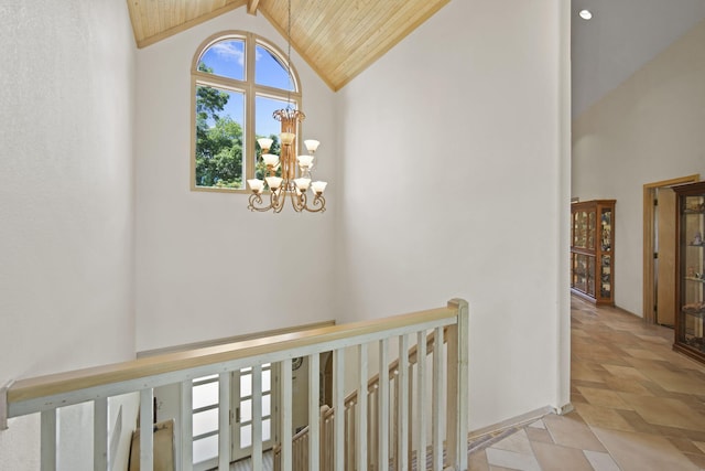 corridor with an inviting chandelier, beamed ceiling, high vaulted ceiling, and wooden ceiling