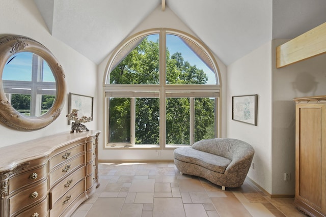 sitting room featuring lofted ceiling with beams