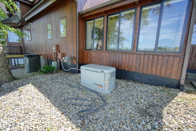 view of side of home with central AC unit