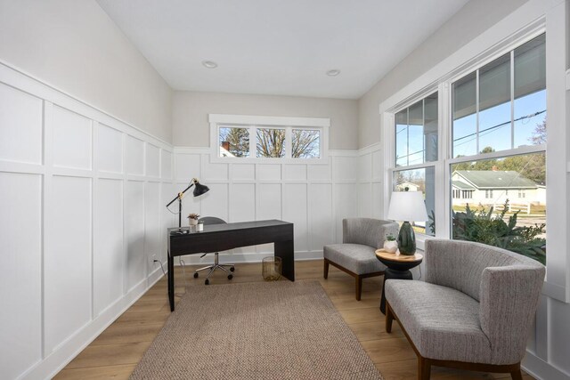 home office with light hardwood / wood-style floors