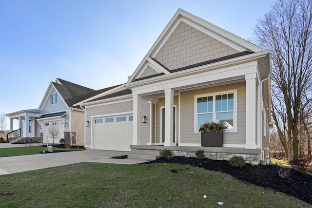 view of front of home with a garage, a front yard, and covered porch