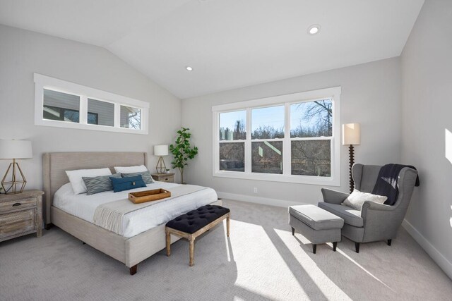 bedroom with vaulted ceiling and light colored carpet