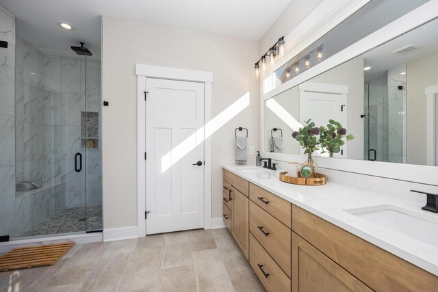 bathroom featuring vanity and a shower with door