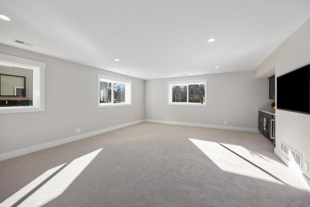 unfurnished living room featuring light carpet