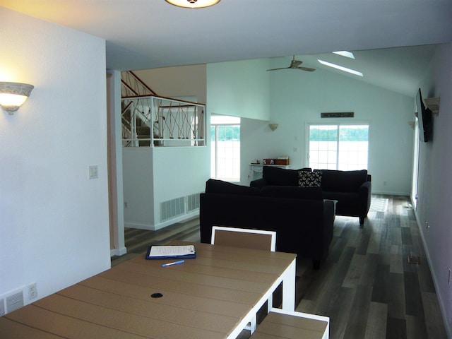 dining space with dark hardwood / wood-style flooring, vaulted ceiling, and ceiling fan