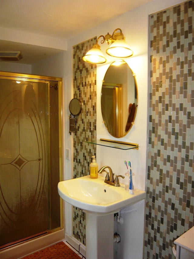 bathroom with an enclosed shower and backsplash