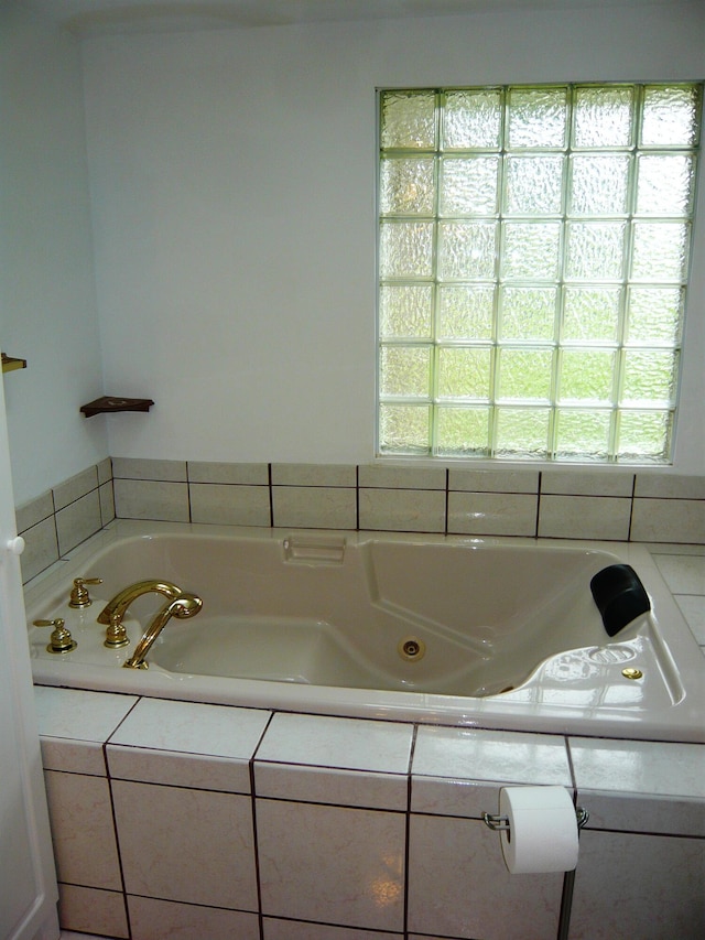 bathroom featuring a relaxing tiled tub