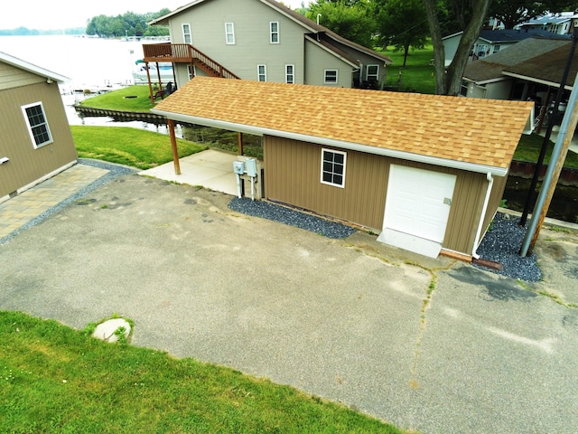 exterior space with a carport and a water view