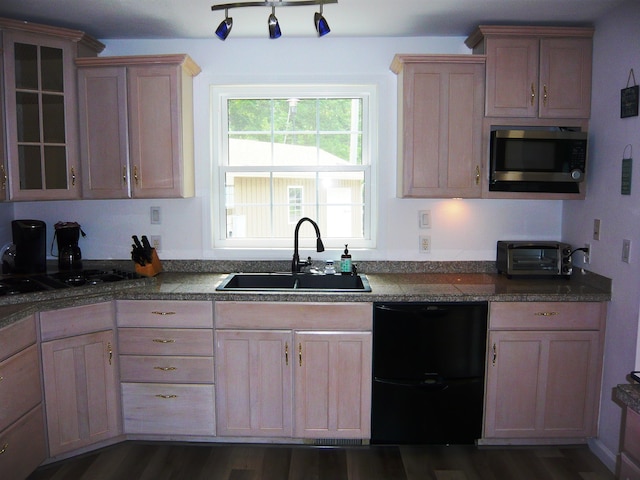 kitchen with dishwashing machine, sink, dark wood-type flooring, and light brown cabinets