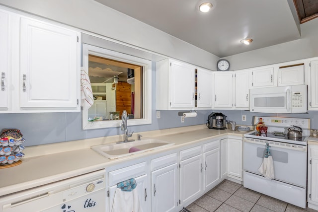 kitchen with white appliances, sink, and white cabinets