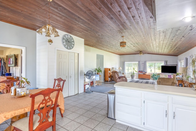 kitchen with light tile patterned floors, white cabinets, decorative light fixtures, vaulted ceiling, and wooden ceiling