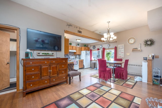 interior space featuring light hardwood / wood-style flooring and a notable chandelier