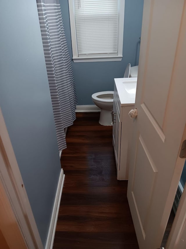 bathroom featuring vanity, hardwood / wood-style floors, and toilet