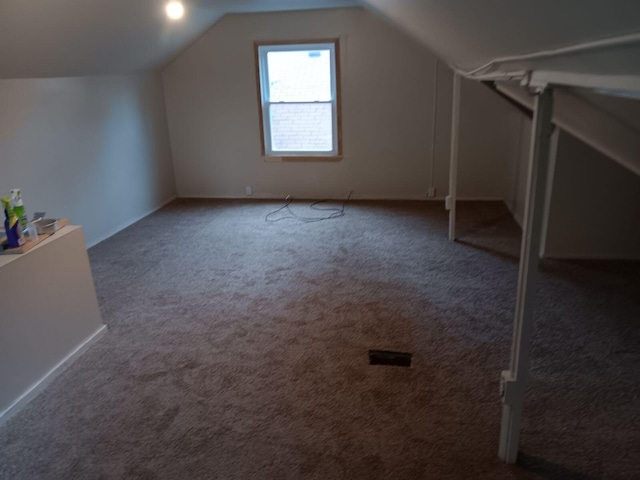 bonus room featuring lofted ceiling and carpet floors