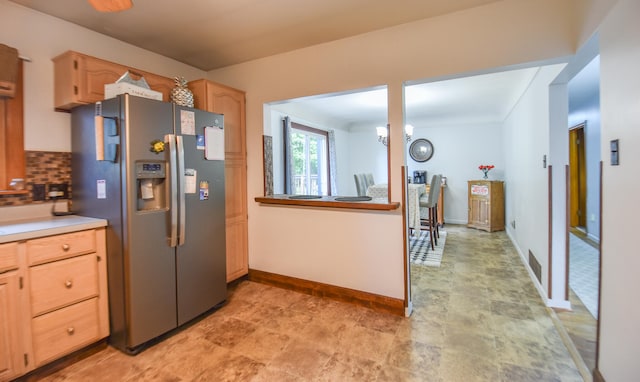 kitchen featuring light brown cabinetry, backsplash, a notable chandelier, and stainless steel refrigerator with ice dispenser