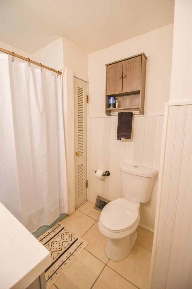 bathroom with tile patterned flooring and toilet