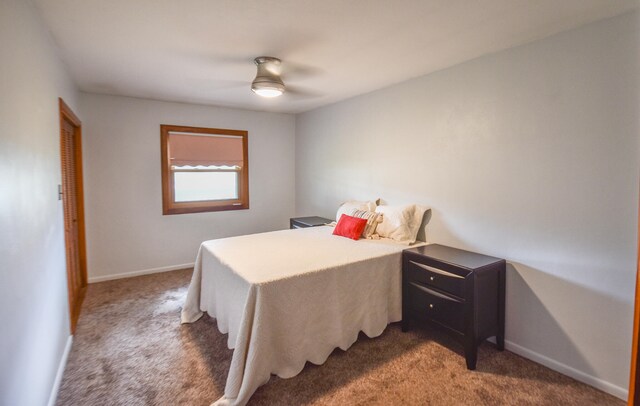 bedroom with dark colored carpet and ceiling fan