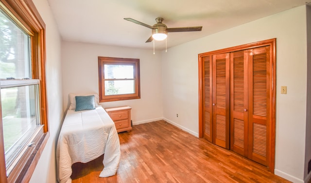 bedroom with hardwood / wood-style flooring, a closet, and ceiling fan