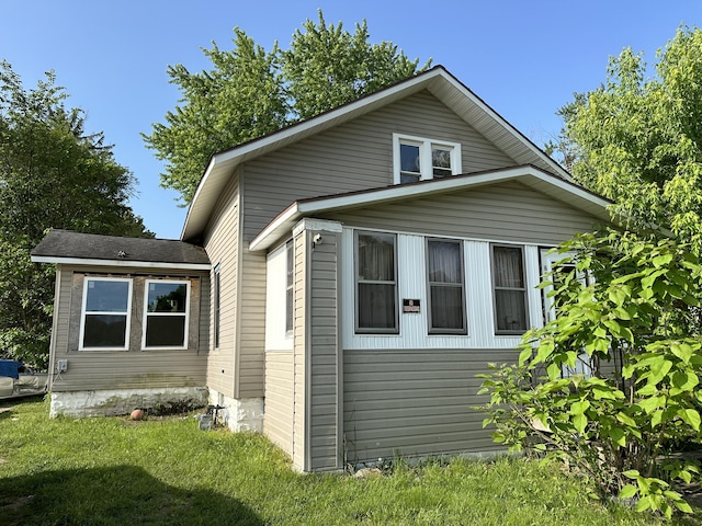 view of side of property with a lawn