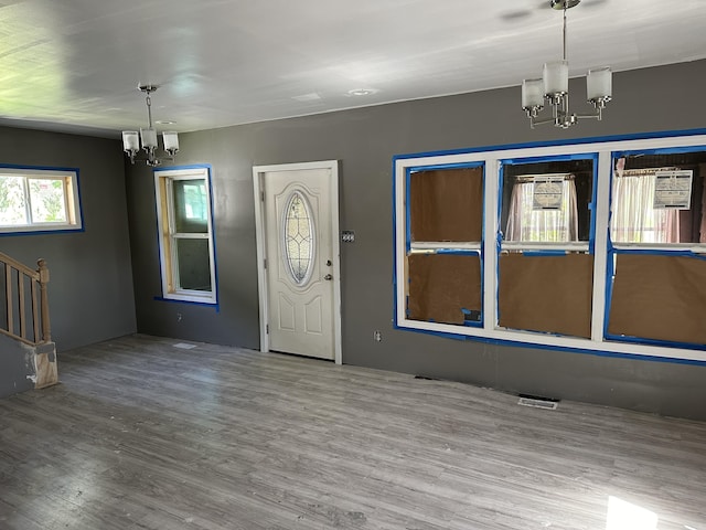 entryway featuring a chandelier and wood-type flooring