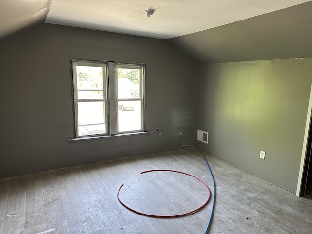 bonus room featuring light hardwood / wood-style flooring and vaulted ceiling