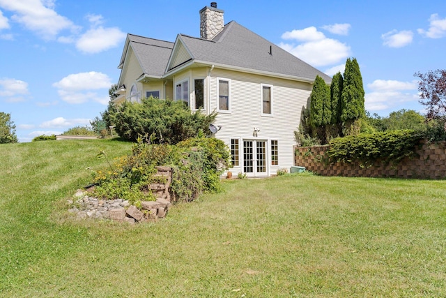 back of house with a yard and french doors