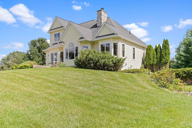 rear view of house featuring a yard