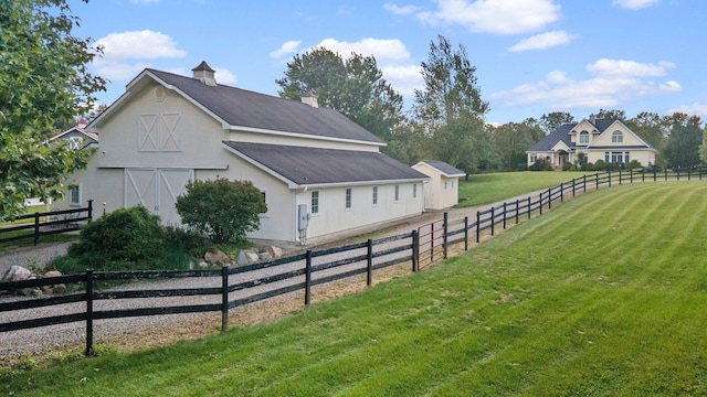 view of property exterior with an outbuilding and a lawn