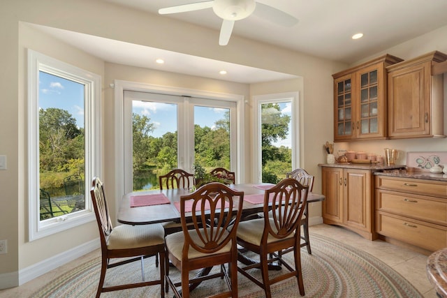 tiled dining space featuring ceiling fan