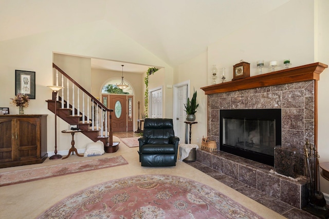 living room featuring lofted ceiling, a tiled fireplace, and carpet floors