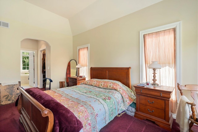 bedroom with connected bathroom and carpet floors